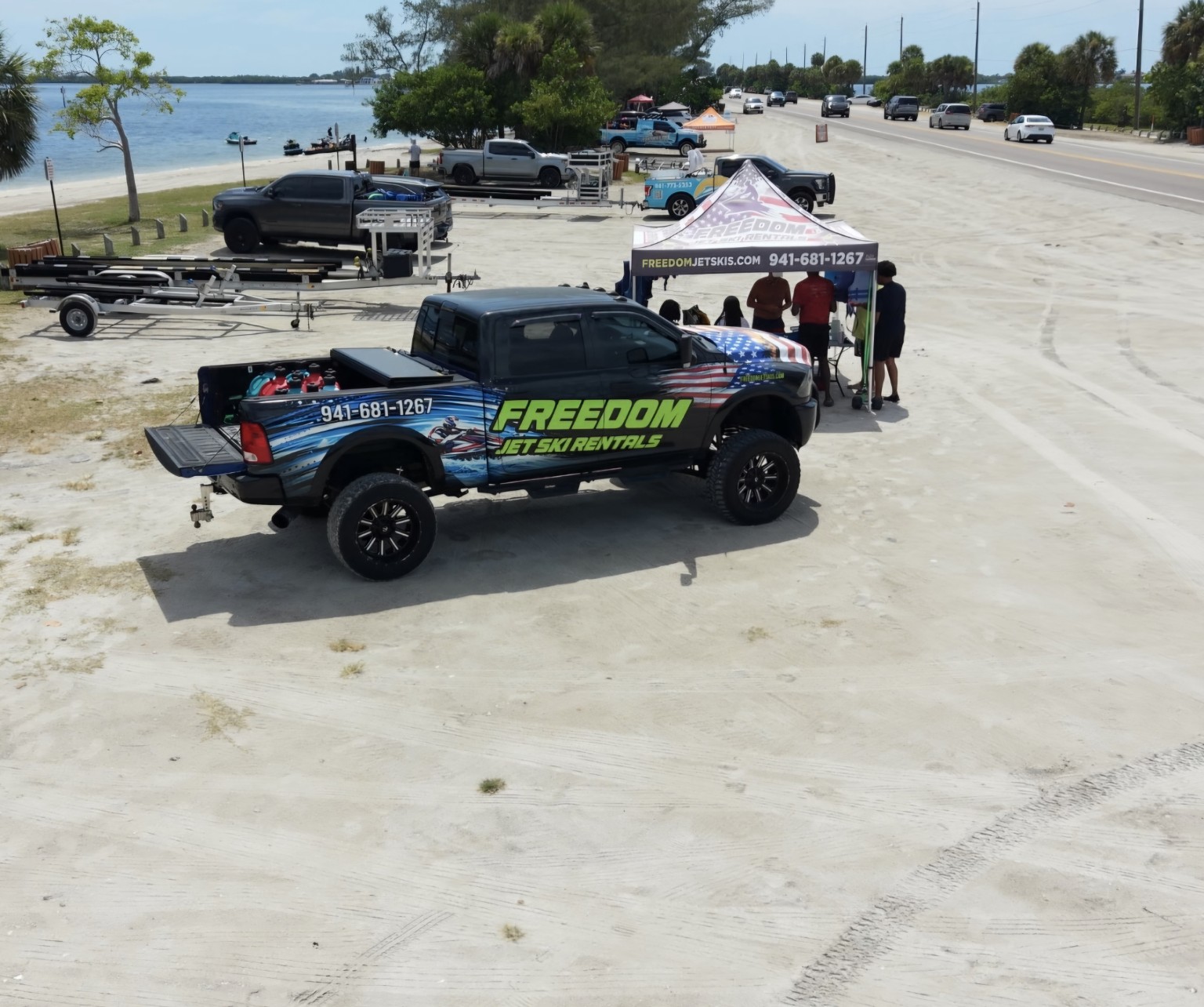 Freedom Jet Ski Rentals branded truck and check-in tent on Palma Sola Causeway
